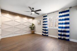 an empty room with a fine tuned lighting fan on ceiling
